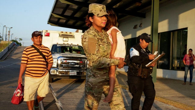 Polisi menggendong anak korban kekerasan sekte agama di Panama. Foto: AP Photo/Arnulfo Franco