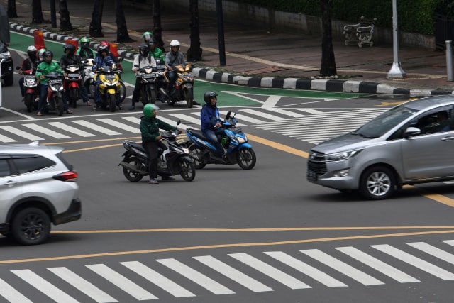 Dua pengendara sepeda motor berhenti di dalam Kotak Kuning Persimpangan (Yellow Box Junction) saat lampu merah menyala di Jalan MH Thamrin, Jakarta. Foto: ANTARA FOTO/Aditya Pradana Putra