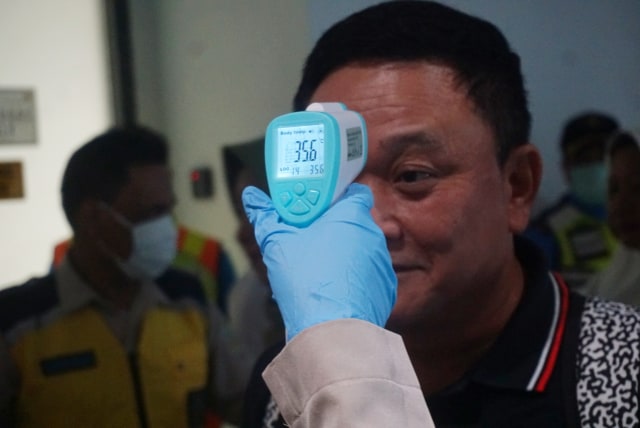 Petugas mengecek penumpang menggunakan Thermal Scanner di Bandara Soekarno Hatta Terminal 3 CGK. Foto: Iqbal Firdaus/kumparan