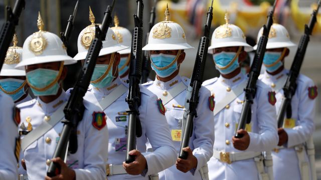 Penjaga Kerajaan Thailand menggunakan masker berjaga di dalam Istana Kerajaan di Bangkok, Thailand. Foto: REUTERS / Jorge Silva