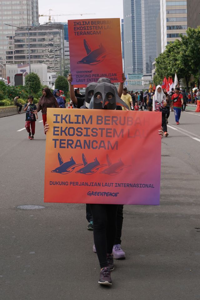 Aktivis Greenpeace membawa poster saat menggelar aksi di kawasan MH Thamrin, Jakarta, Minggu (9/2). Foto: Fanny Kusumawardhani/kumparan