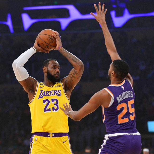 Pemain Los Angeles Lakers, LeBron James, dikawal pemain Phoenix Suns. Foto: Gary A. Vasquez-USA TODAY Sports via Reuters