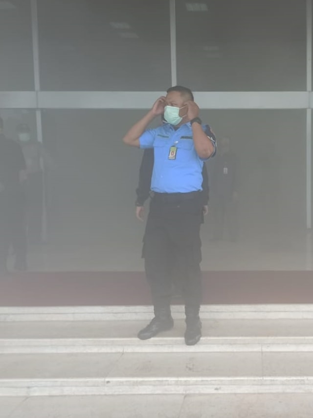 Sejumlah petugas keamanan mengenakan masker di lokasi kepulan asap di Gedung Nusantara II, DPR RI, Jakarta, Senin (24/2). Foto: Hemi Afandi/kumparan