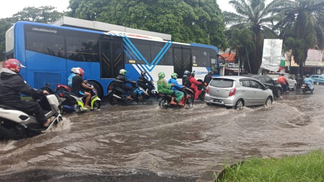 Sejumlah kendaraan melintas banjir yang merendam Jalan Raya Ciledug arah Jakarta, Selasa (25/2).  Foto: Rafael Ryandika/kumparan