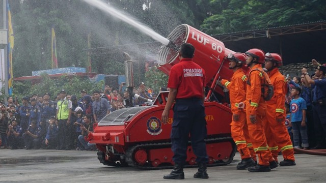 Petugas PJLP melakukan simulasi pemadaman dengan  Robot Damkar di Dinas Penanggulangan Kebakaran dan Penyelamatan DKI Jakarta, Minggu (1/3). Foto: Fanny Kusumawardhani/kumparan