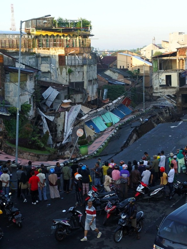 Warga melihat pertokoan Jompo yang ambruk di Jalan Sultan Agung Jember, Jawa Timur. Foto: ANTARA FOTO/Seno