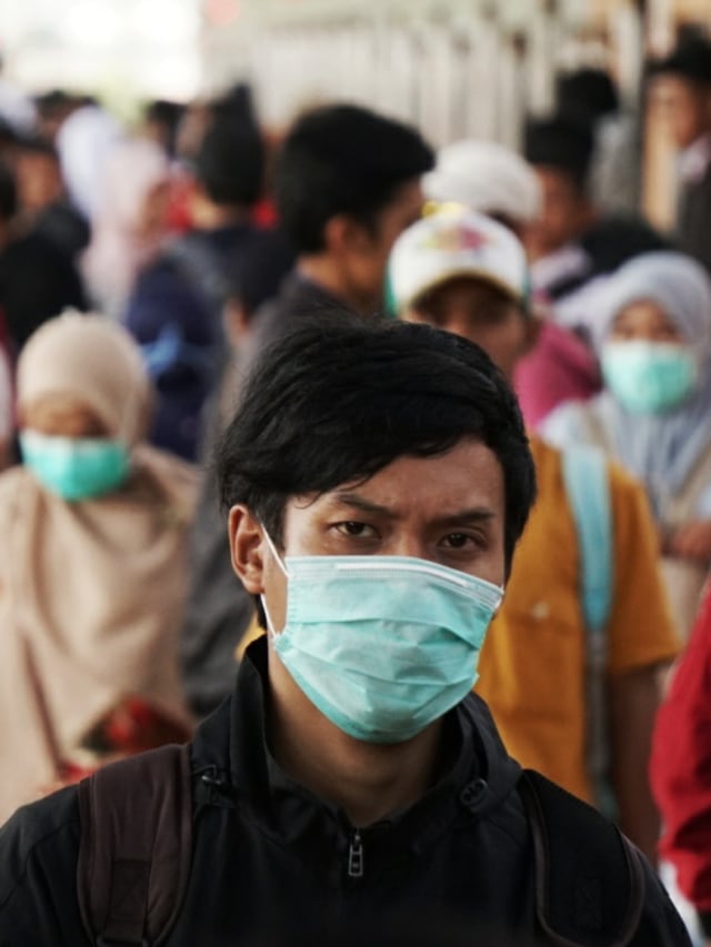 Seorang penumpang menggunakan masker berjalan di Stasiun Depok, Depok, Jawa Barat, Senin (2/3). Foto: Jamal Ramadhan/kumparan 