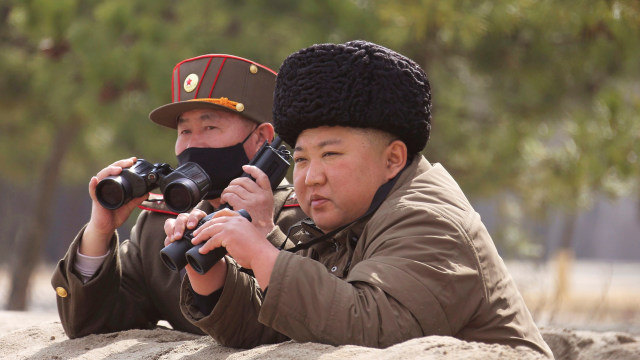 Pemimpin Tertinggi Korea Utara Kim Jong-Un memantau latihan peluncuran rudal di dampingi seorang perwira militer, Senin (9/3). Foto: KCNA via Reuters