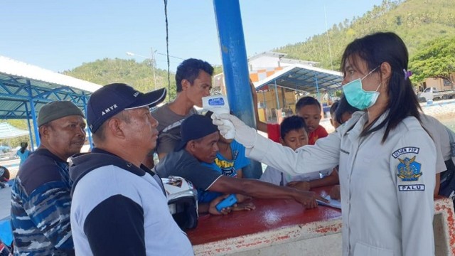 Petugas Pencegahan dan Penanganan COVID-19 Sulteng saat memeriksa suhu tubuh nelayan di Donggala, Sulawesi Tengah. Foto: Istimewa