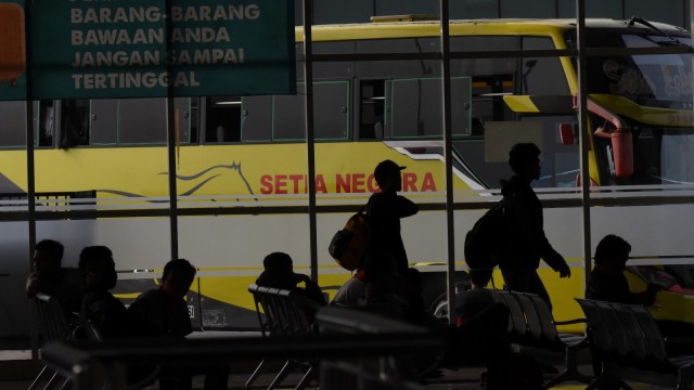 Calon penumpang bersiap menaiki bus Antar Kota Antar Provinsi di Terminal Pulo Gebang, Jakarta, Minggu (29/3/2020) Foto: ANTARA FOTO/M Risyal Hidayat