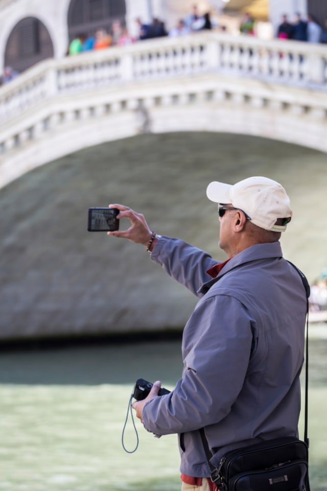 Wisatawan yang tengah berfoto di sekitar Jembatan Rialto yang ada di sekitar kanal Venesia. Foto: Shutter Stock