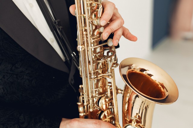 person-holding-brass-saxophone-3984800.jpg