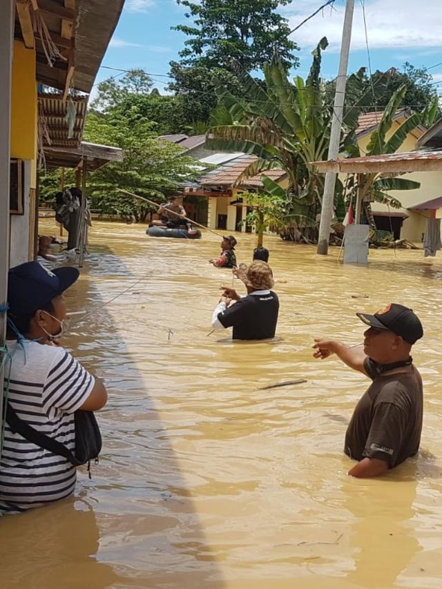 Warga dan petugas mengevakuasi barang yang terendam banjir di Batu Sopang Kalimantan Timur. Foto: Dok. BNPB 