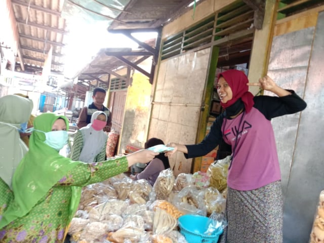 Pedagang menerima makser kain dari Muslimat NU dan PC Fatayat NU Kabupaten Tegal.