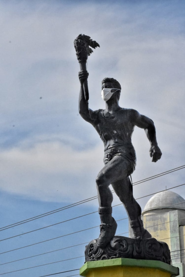 Patung obor yang ada di perempatan Desa Pakembaran, Kecamatan Slawi dipasangi masker, Rabu (8/4/2020). (Foto: Dok. Humas Pemkab Tegal)