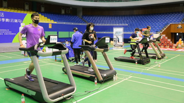 Sejumlah peserta melakukan treadmill untuk memimpin pelari online saat maraton streaming di Shijiazhuang, provinsi Hebei, China, Minggu (12/4).  Foto: Getty Images