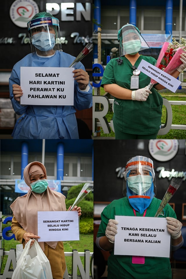 Petugas medis menunjukkan kertas pemberian semangat yang diberikan oleh Komunitas Taman Potret di Rumah Sakit Umum Kota Tangerang, Banten, Selasa (21/4). Foto: ANTARA FOTO/Fauzan
