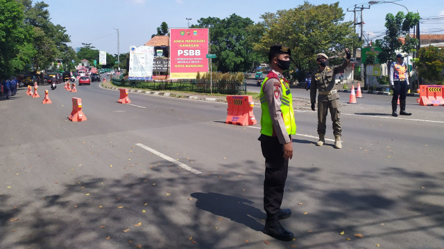Petugas berjaga di salah satu check point di Bunderan Cibiru, pemeriksaan dilakukan terhadap pengguna jalan yang memasuki Kota Bandung. Foto: Rachmadi Rasyad/kumparan