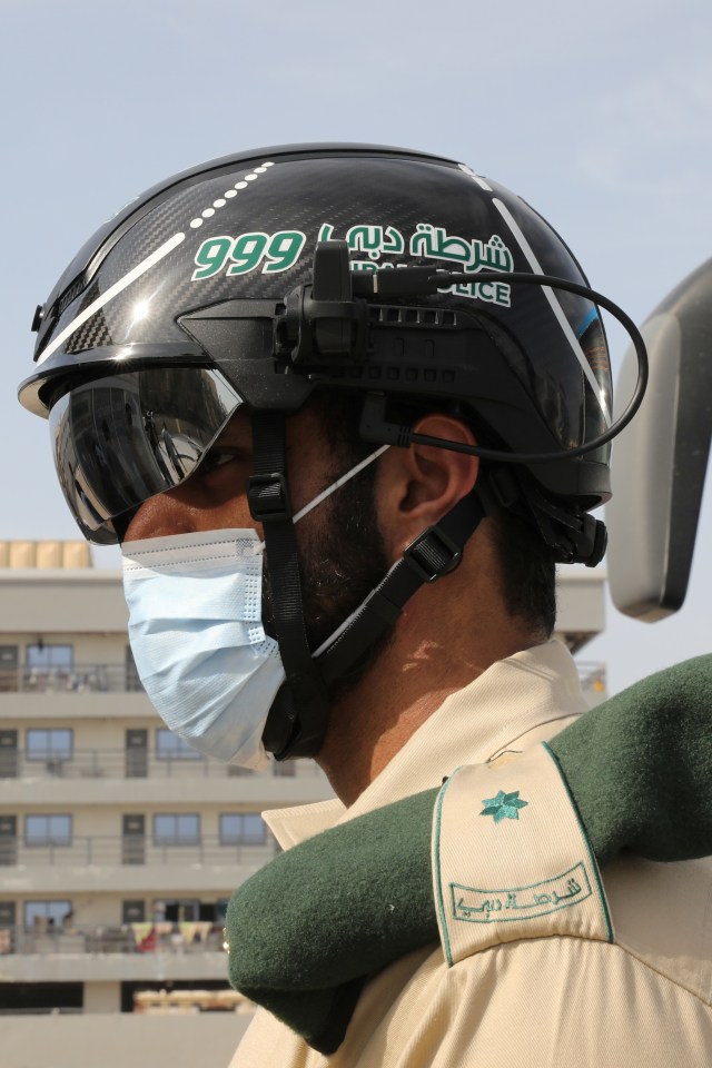 Polisi mengenakan helm pintar pendeteksi suhu tubuh di Dubai, Uni Emirat Arab, Kamis (23/4). Foto: REUTERS / Ahmed Jadallah