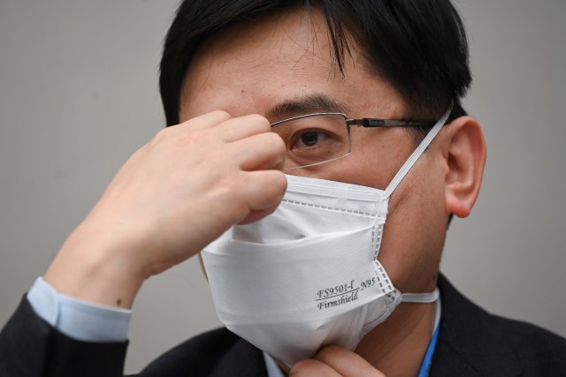 Iustrasi pria China bermasker. Foto: AFP/Wang Zhao