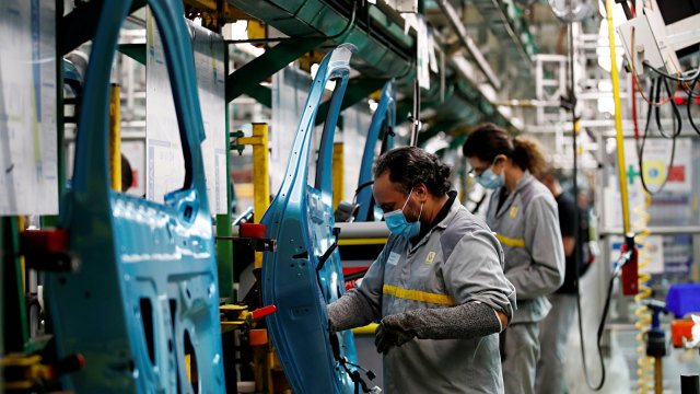 Pekerja yang menggunakan masker melakukan perakitan mobil di pabrik mobil Renault di Flins, Prancis, Rabu (6/5). Foto: REUTERS/Gonzalo Fuentes