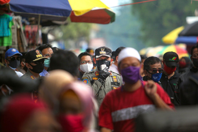 Wali Kota Bogor Bima Arya (tengah) menyampaikan imbauan kepada warga yang berkerumun di Pasar Anyar, Kota Bogor, Jawa Barat, Minggu (17/5/2020) Foto: Antara/Humas Pemkot Bogor