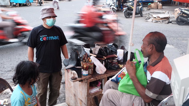 Seorang penjahit sepatu saat meneria bantuan. Foto: Layank