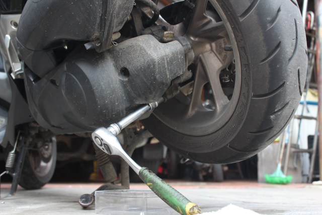 Buka baut tab oli transmisi'gardan dibawah CVT dengan kunci 12 mm. Foto: Bangkit Jaya Putra/kumparan