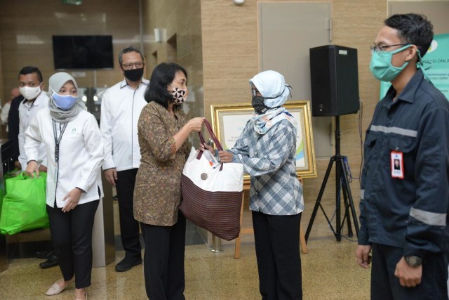Menteri PPPA, Bintang Puspayoga, menyerahkan secara simbolis bantuan paket kebutuhan spesifik perempuan dan anak bagi para PRT. Foto: Kemen PPPA.
