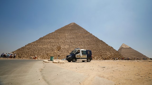 Sebuah kendaraan polisi terlihat di depan Piramida Giza, Kairo, Mesir. Foto: Mohamed Abd El Ghany/Reuters