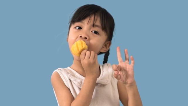 Anak makan nanas. Foto: Shutterstock