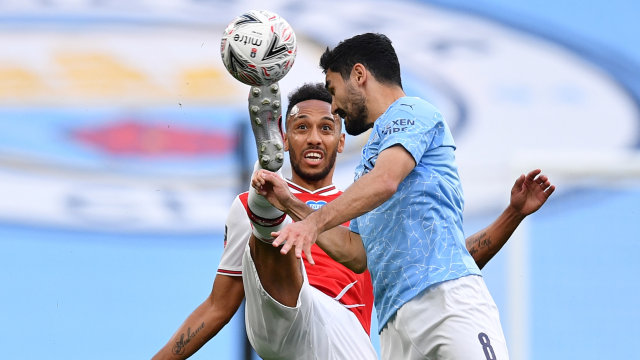 Pemain Arsenal, Pierre-Emerick Aubameyang (kiri) berduel dengan
Pemain Machester CIty lkay Gundogan saat pertadinga Semi FInal Piala FA. Foto: Justin Tallis - Reuters