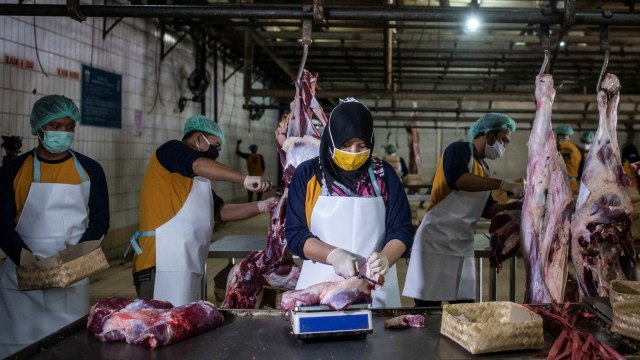 Pekerja memotong daging sapi kurban di Rumah Pemotongan Hewan (RPH) PD Dharma Jaya, Cakung, Jakarta. Foto: Aprillio Akbar/Antara Foto