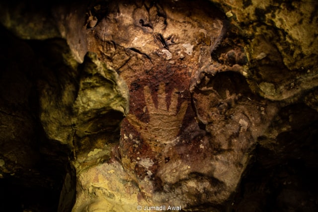 Terisolasi dari peradaban, lukisan prasejarah berbentuk tangan ini adalah refleksi hubungan antar manusia prasejarah sebagai bentuk komunikasi satu sama lain. (Foto: Jumadil Awal)