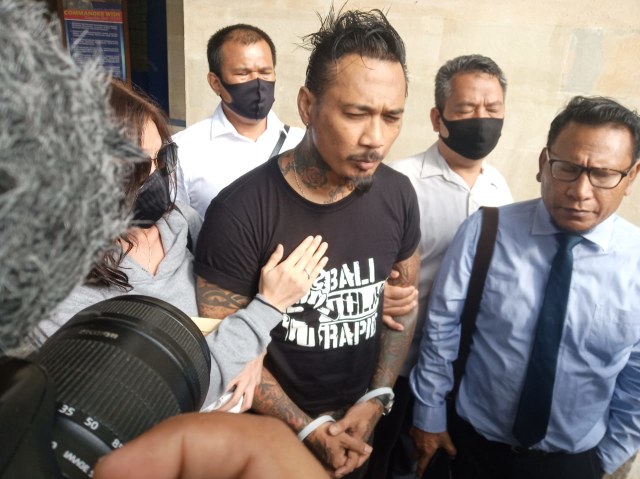 Jerinx dengan tangan diborgol usai menjalani pemeriksaan di Polda Bali dan langsung ditahan - WIB