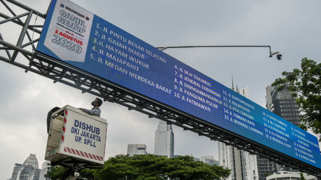 Petugas Dinas Perhubungan DKI Jakarta mengecek papan informasi mengenai kebijakan sistem pembatasan kendaraan bermotor berdasarkan nomor plat nomor ganjil-genap di kawasan Jalan Sudirman, Jakarta, Senin (24/8). Foto: Galih Pradipta/ANTARA FOTO