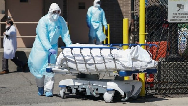 Ilustrasi - Tim medis membawa jenazah pasien COVID-19 (Foto: Foto: AFP/Bryan R Smith)