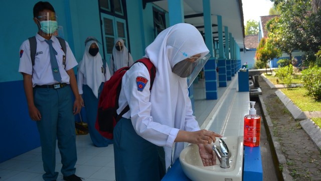 Sejumlah siswa mencuci tangannya dengan sabun sebelum masuk ke dalam kelas untuk mengikuti kegiatan belajar mengajar (KBM) tatap muka terbatas di SMA Negeri 3, Kabupaten Jombang, Jawa Timur, Senin (7/9). Foto: Syaiful Arif/ANTARA FOTO