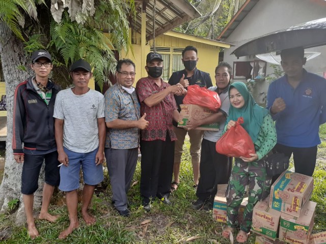 Penyerahan bantuan banjir secara simbolis oleh Kasi Perlindungan Sosial, Poniman kepada Camat Dedai, Halim Hartadi. Foto: Dok. Poniman