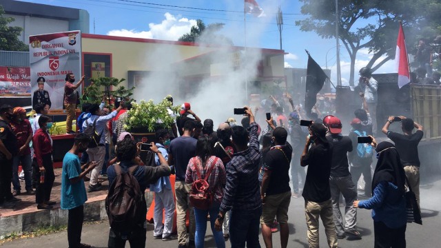Mahasiswa dan warga Loloda saat melakukan aksi di depan Polda Maluku Utara di Ternate. Mereka menuntut proses hukum dugaan rasisme yang dilakukan Bupati Halmahera Utara terharap warga Loloda. Foto: Samsul.