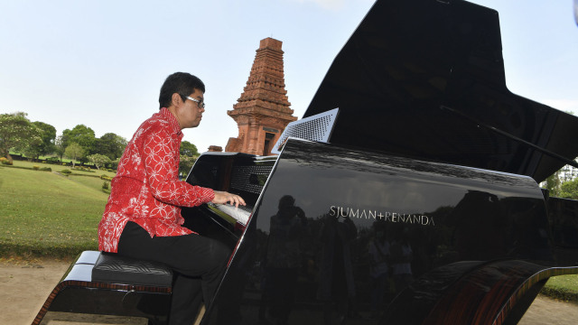 Pianis dan komponis Ananda Sukarlan memainkan piano Sjuman Renanda grand piano pertama buatan Indonesia pada rangkaian konser  Raspodia Nusantara dan Kejayaan Nusantara di Candi Gapura Bajang Ratu, Trowulan, Mojokerto  Jawa Timur, Sabtu (3/10/2020). Foto: Zabur Karuru/ANTARA FOTO