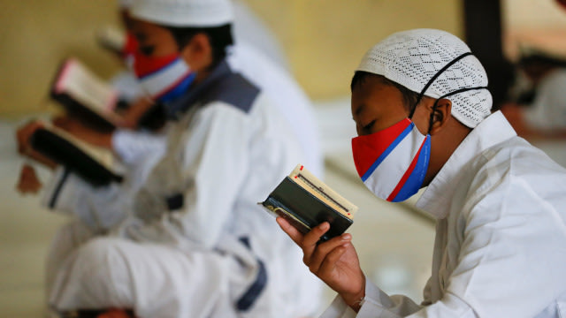Santri mengaji dengan menggunakan masker dan menerapkan jarak fisik di Pondok Pesantren Daarul Qur'an Al Kautsar, Bogor. Foto: REUTERS/Willy Kurniawan