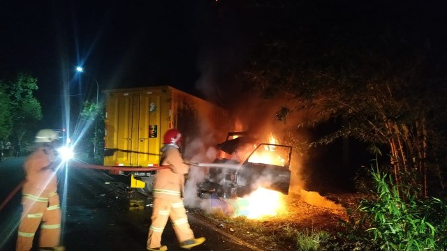 Petugas saat berupaya memadamkan api kendaraan yang terlibat kecelakaan lalu-lintas di jalan raya jurusan Bojonegoro - Nganjuk, turut wilayah Desa Kunci Kecamatan Dander Kabupaten Bojonegoro, Minggu (18/10/2020) 