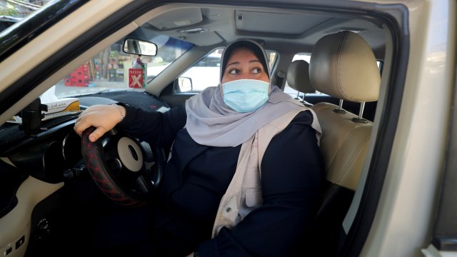 Naela Abu Jibba memulai layanan taksi khusus wanita saat mengemudikan kendaraannya di Gaza. Foto: Mohammed Salem / REUTERS