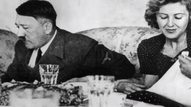 Pemimpin Nazi, Adolf Hitler sedang bersama dengan pasangannya Eva Braun dalam sebuah pertemuan. Foto: dok. Youtube/The Story Behind