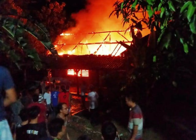 Sejumlah warga berkerumun melihat peristiwa kebakaran pabrik penggilingan padi di Desa Sumber Jaya, Kabupaten Kuningan, Jawa Barat. (Andri Yanto)