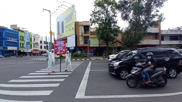 Prihatin Corona semakin Meningkat, 2 Warga Solo Pakai Baju Hazmat di Perempatan (58939)