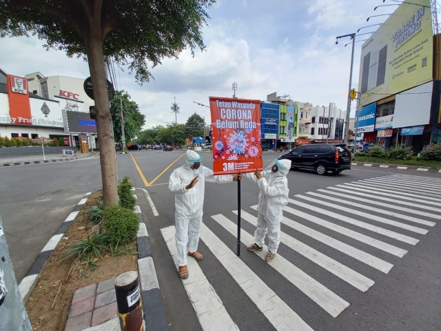 Prihatin Corona semakin Meningkat, 2 Warga Solo Pakai Baju Hazmat di Perempatan (58940)