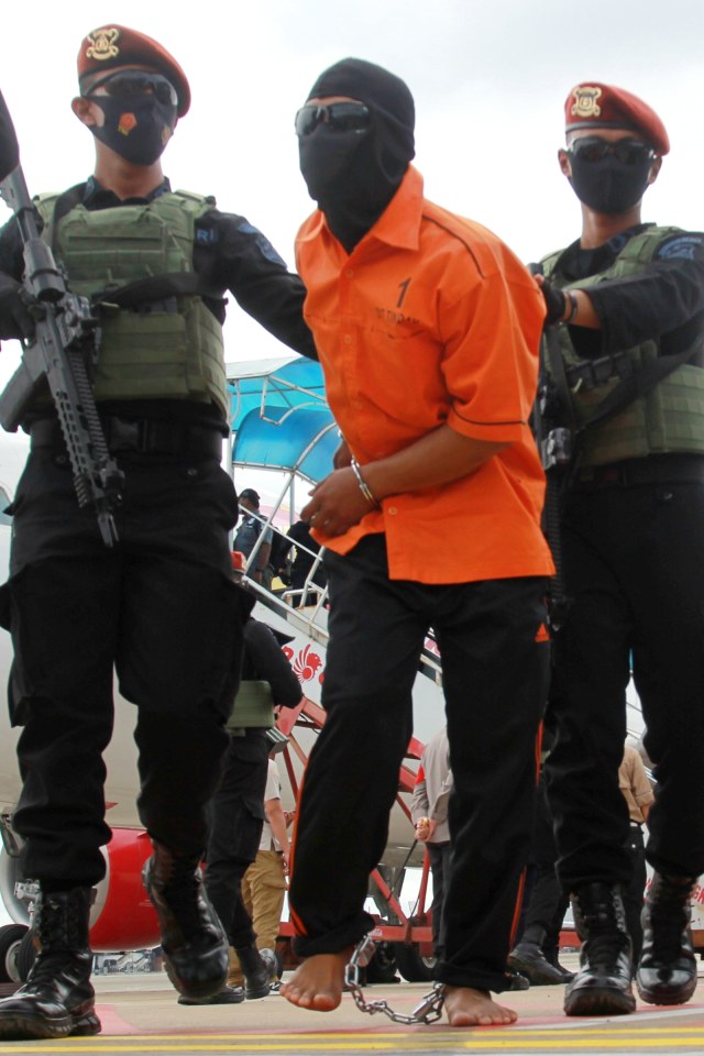 Petugas Densus 88 membawa terduga teroris dari Lampung setibanya di Bandara Soekarno Hatta, Tangerang, Banten, Rabu (16/12). Foto: Muhammad Iqbal/ANTARA FOTO