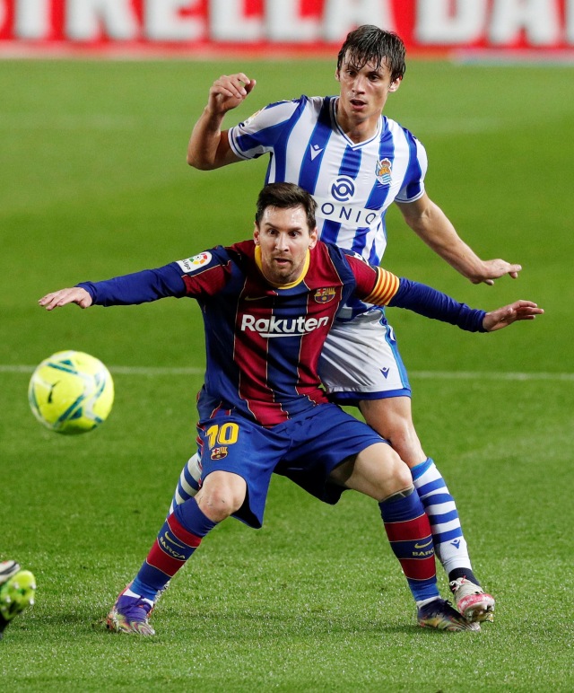 Pemain FC Barcelona Lionel Messi berebut bola dengan pemain Real Sociedad pada pertandingan lanjutan Liga Spanyol di Camp Nou, Barcelona, Spanyol. Foto: Albert Gea/REUTERS